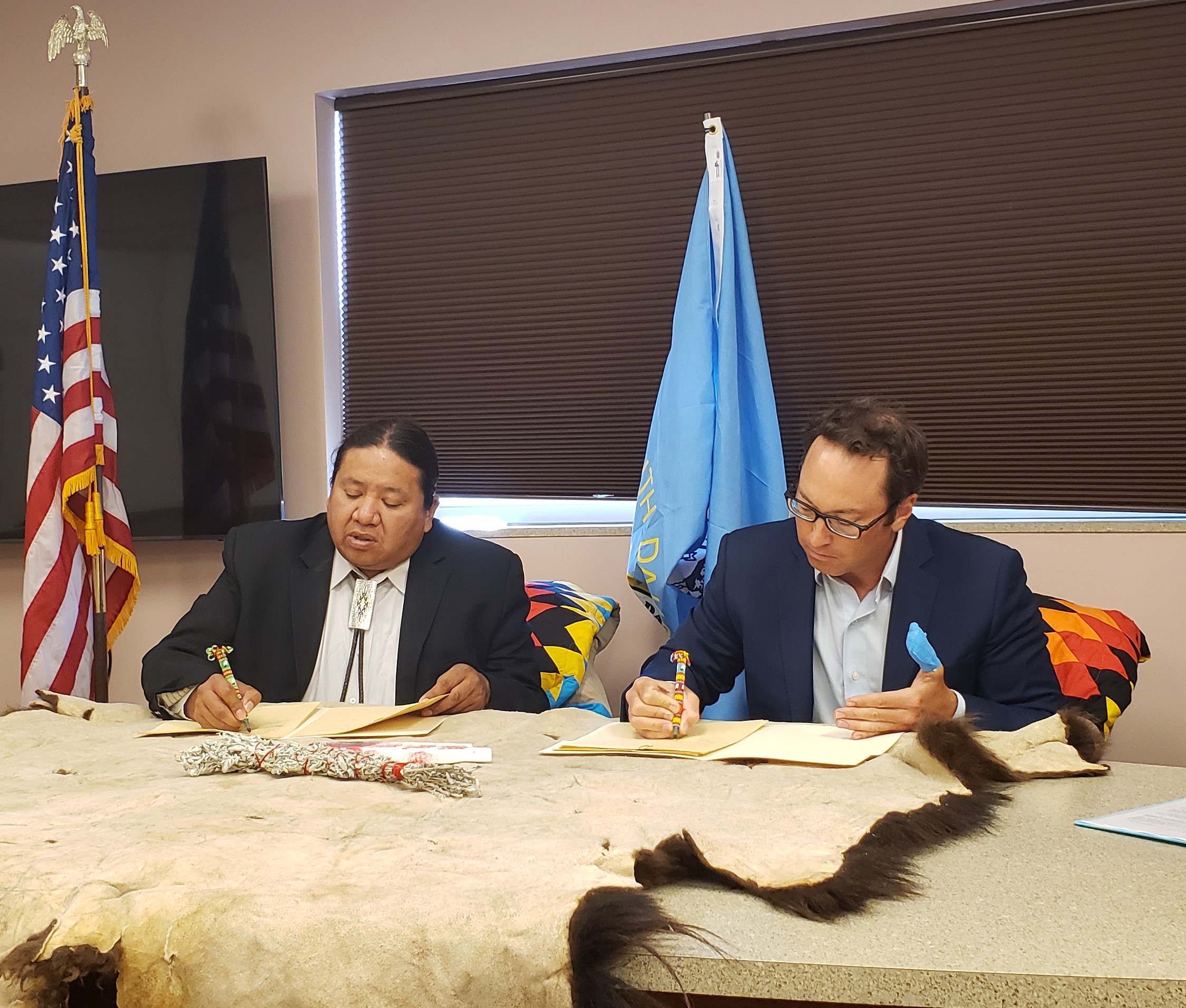 Secretary Barnett and Tribal President Killer sign the MOU - Aug 29, 2022